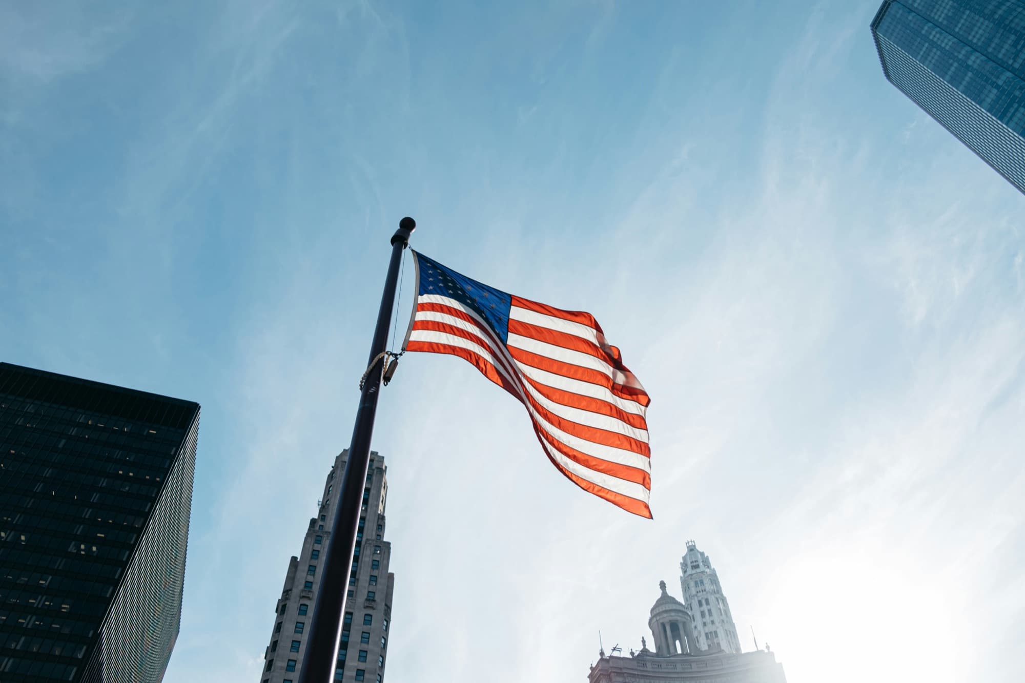 A United States flag flying between downtown towers